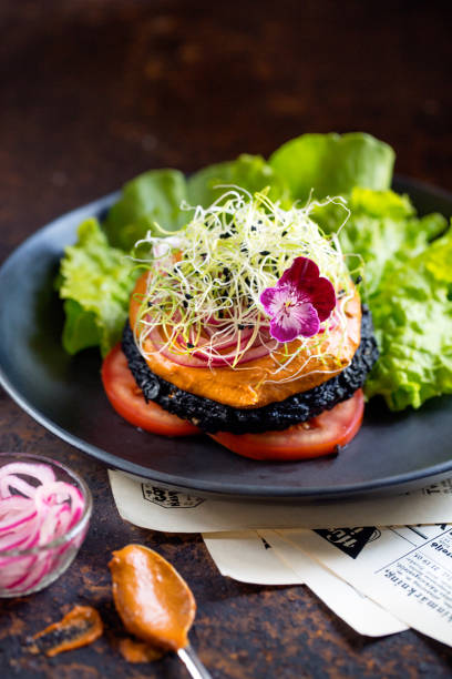 istock Raw food mushroom burger on black plate 2190202709