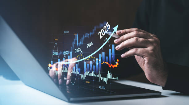 istock Hand pointing at a financial graph with a 2025 forecast on a laptop screen. 2190203176