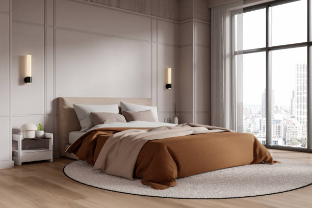 istock Modern bedroom interior with large windows, featuring a neutral color scheme, a cozy bed, and cityscape views, creating a tranquil atmosphere. 3D Rendering 2190204211