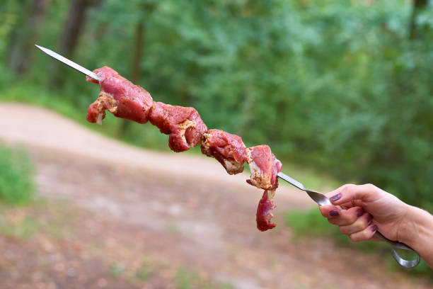 the flesh of an animal especially a mammal as food for grill on fire