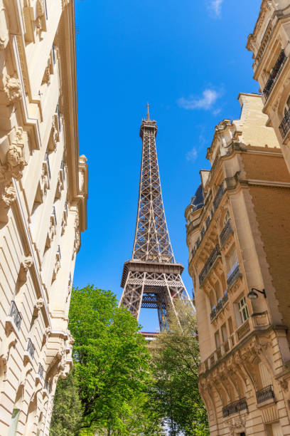istock The Eiffel Tower between buildings against clear blue sky in Paris, France 2190210306