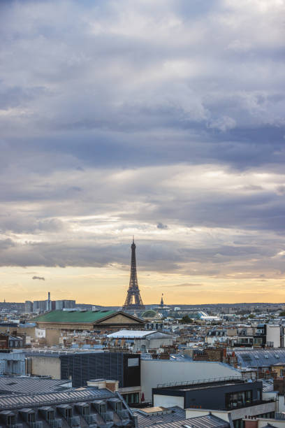 istock The Eiffel Tower rising above city skyline under the overcast at sunset 2190210504