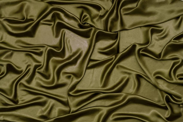 istock Silk luxurious fabric texture, material, background wallpaper texture, olive color background 2190212818