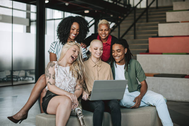 istock Group of coworkers looking at laptop 2190213547