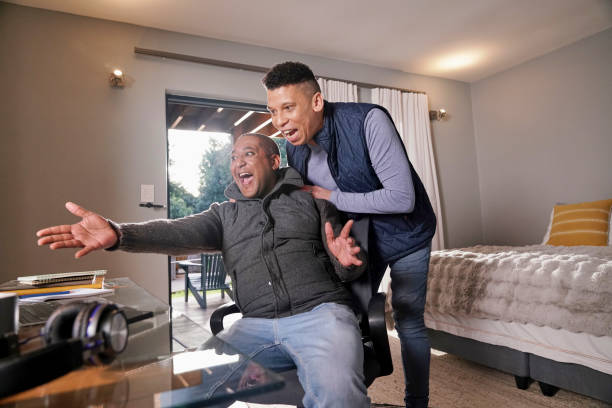istock Gay couple looking at laptop 2190213730