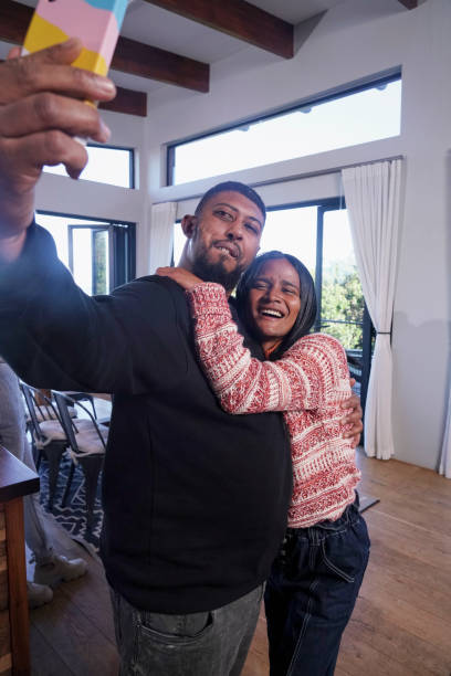istock Friends taking selfie at home 2190215351
