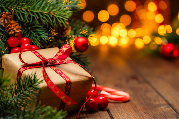 istock Brown Christmas present on a cozy table with defocused Christmas lights at background 2190215860