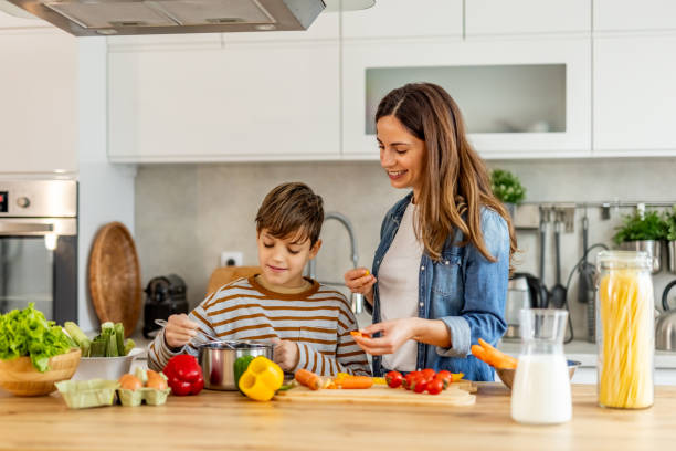 istock Mother and son bonding while cooking together in a contemporary kitchen 2190215936