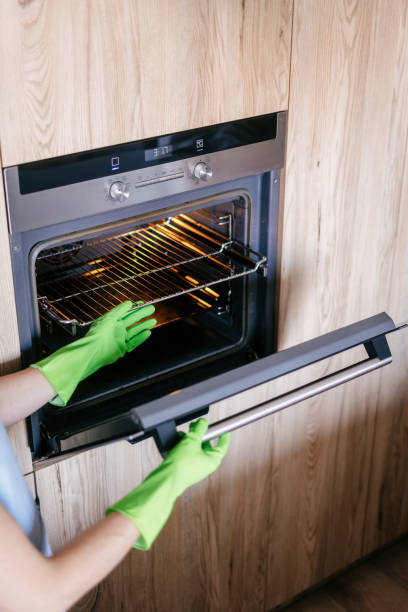 istock Cleaning the modern oven in a stylish kitchen by a dedicated housekeeper 2190216073