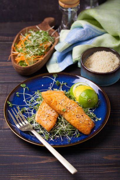 istock Fried salmon steak with microgreens, lemon and lime 2190216792