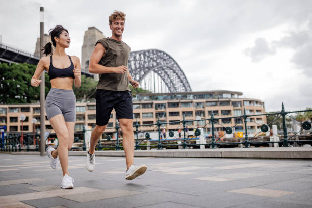 istock Young people jogging outdoors in Sydney near Harbor Bridge 2190221175