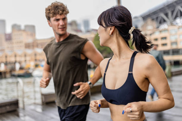 istock Two friends jogging outdoors near the city waterfront for exercise 2190221394