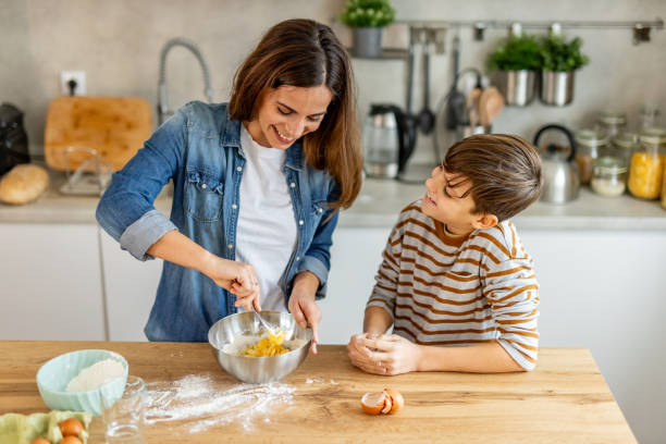 istock Mother and son having a great time bonding in the kitchen while making dough, mixing ingredients, and sharing laughter 2190221399