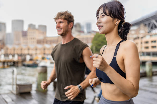 istock Two individuals jogging outdoors in a vibrant city area 2190221427