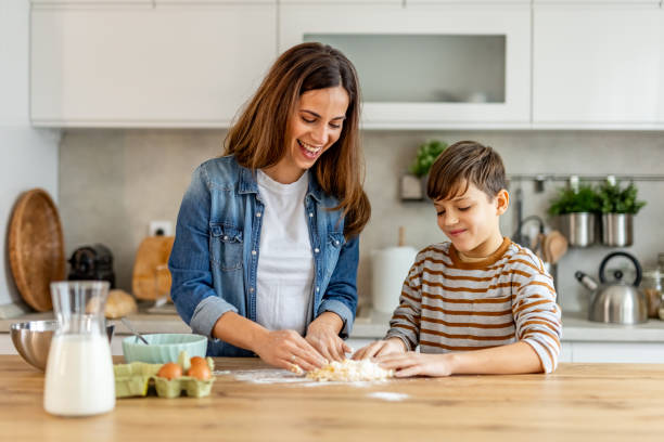 istock Mother and son joyfully making dough in the kitchen, bonding over meaningful moments and shared laughter 2190221456
