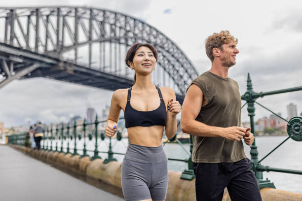 istock Two people jogging near a bridge in Sydney on a cloudy day 2190223146