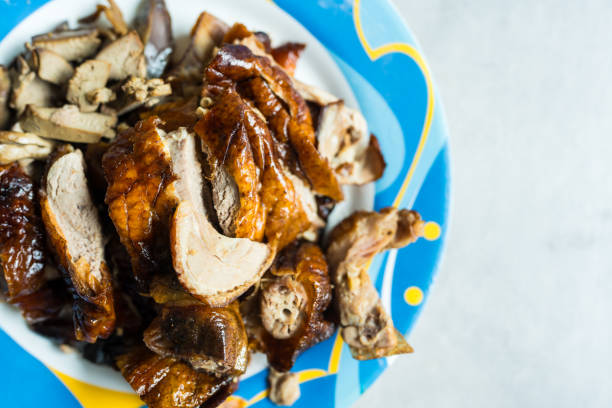 Slice of savoury crispy roast duck served on dish