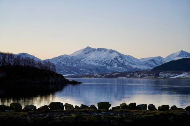 istock Snow-capped mountains reflecting in a tranquil lake at dusk 2190226270