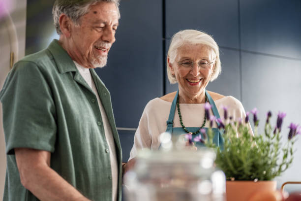 istock Senior Couple Smiling Together While Gardening Indoors 2190227180