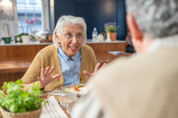 istock Elderly Woman Enjoying a Conversation at the Dinner Table 2190227279
