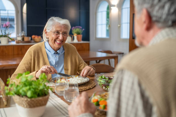 istock Elderly Woman Smiling and Talking to her Husband While Dining 2190227290
