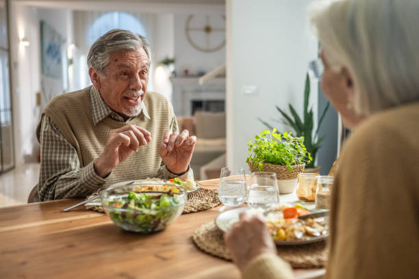 istock Elderly Couple Enjoying a Meal Together 2190227321