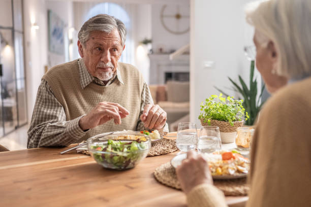 istock Elderly Couple Sharing a Meal at Home 2190227334