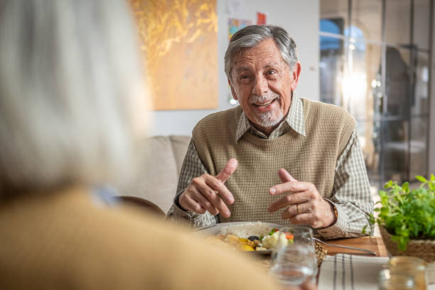 istock Smiling Senior Couple Enjoying a Meal Together 2190227344