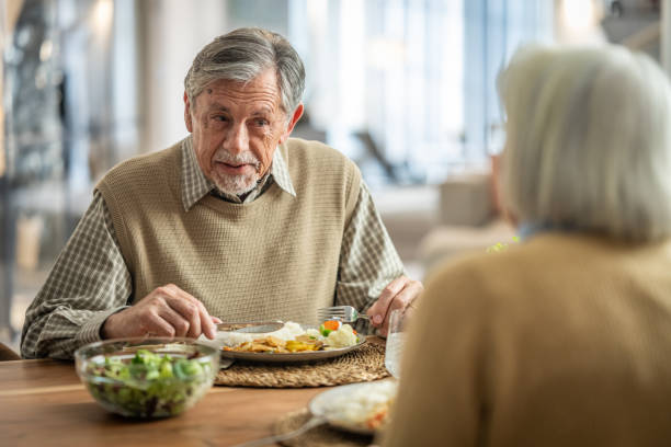 istock Senior Man Enjoying a Conversation at the Dining Table 2190227361