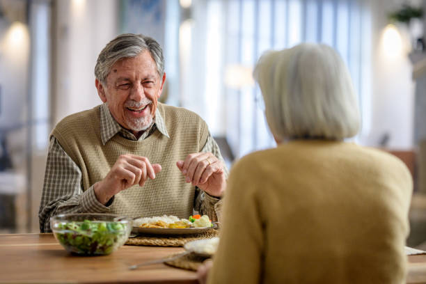 istock Elderly Couple Sharing a Joyful Conversation Over a Meal 2190227377