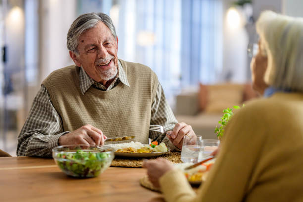 istock Elderly Couple Enjoying a Meal Together 2190227400