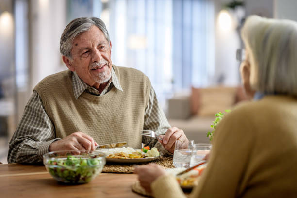 istock Elderly Couple Sharing a Meal and Heartfelt Conversation 2190227401