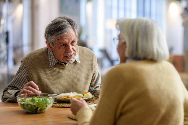 istock Elderly Couple Sharing a Meal and Conversation 2190227402