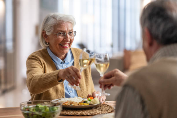 istock Elderly Couple Toasting During a Warm Dinner 2190227451