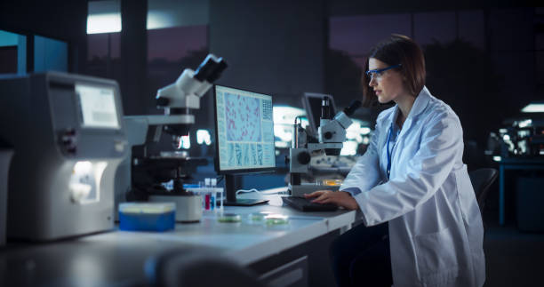istock Medical Research and Development Laboratory: Dedicated Caucasian Female Scientist Working on a Computer with Advanced DNA Diagnostic Software. Modern Genetic Engineering Lab at Night 2190227984