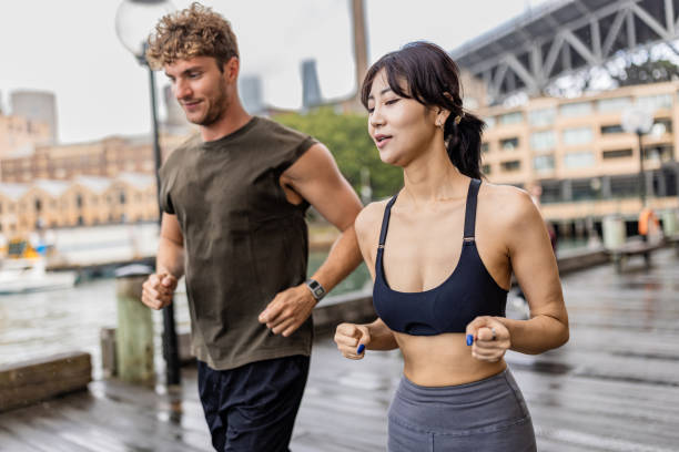 istock Active couple running outdoors near iconic Sydney harbor bridge 2190228048