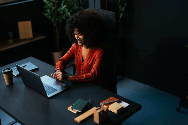 istock Smiling young manager working on laptop in modern office 2190232069