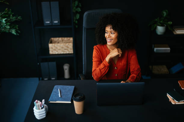 istock Smiling businesswoman working on laptop in modern office 2190232071