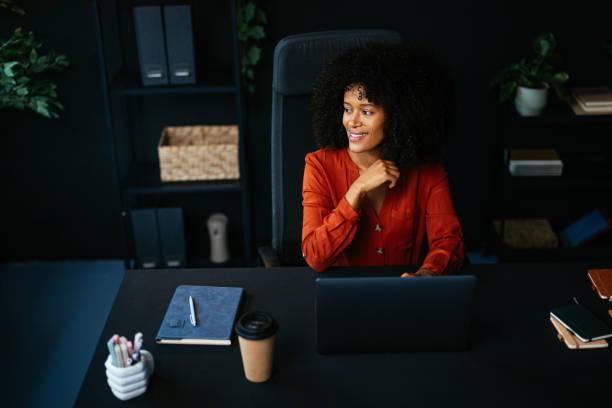 istock Young manager working with laptop in modern office looking away and smiling 2190232079