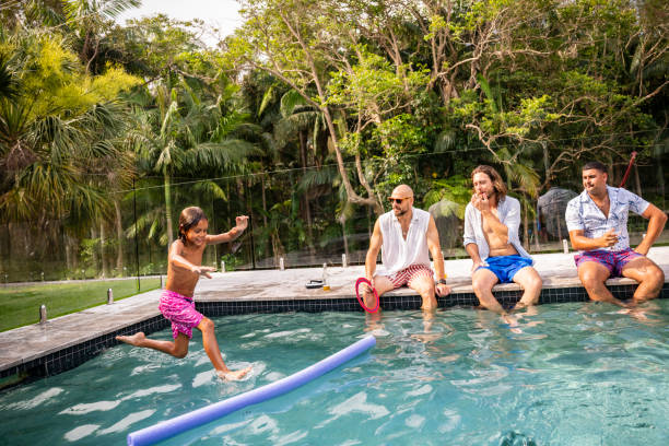 istock Young boy jumping on noodle float in swimming pool 2190233719