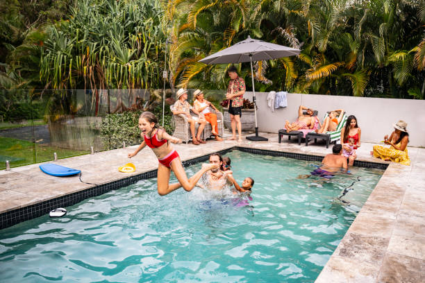 istock Father and young daughter playing in swimming pool 2190233743