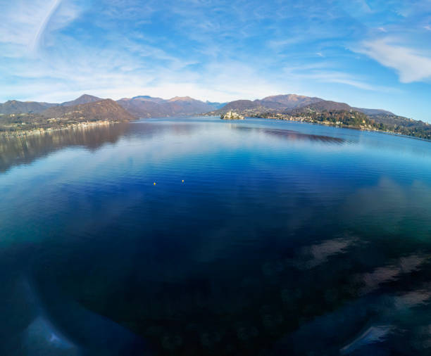 Aerial view, taken by drone, of the Orta Lake with San Giulio Island. It's a small glacial origin lake in Northern Italy (Piedmont Region, at the slope of Italy Alps) and UNESCO site.