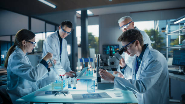 istock PhD Professor Teaching a Group of Science Students the Basics of Gene Therapy and Biological Engineering. Head of Laboratory Creating Conditions for Practical Education and Technology Demonstration 2190239536