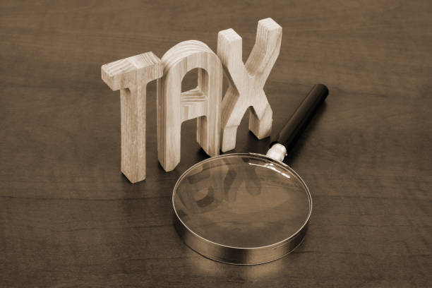 istock Letters tax and magnifying glass. 2190242407