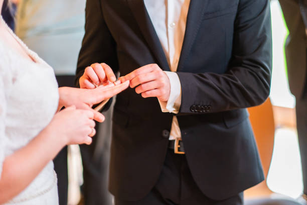 istock Couple Exchanging Wedding Rings During a Joyous Marriage Ceremony 2190243506