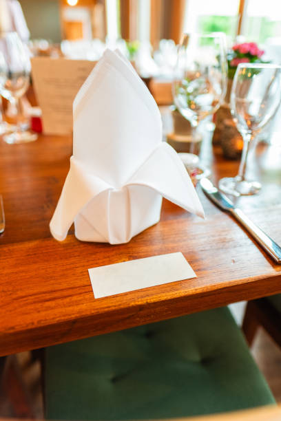 istock Elegant Table Setting Featuring White Linen Folded Napkin and Reserved Name Card at Fine Dining Event or Celebration 2190243559