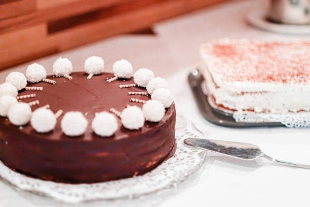 Chocolate cake with white coconut decorations and tiramisu on a serving plate, creating a delightful dessert presentation. Perfect for parties, events, or any celebration moment.