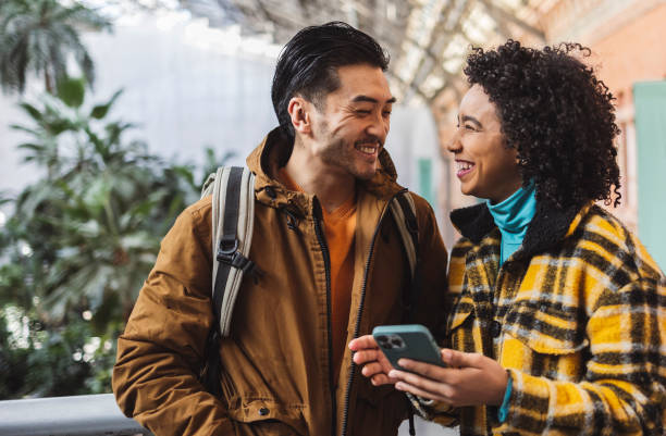 istock Travelers consulting their smartphone, smiling and having fun together 2190245980