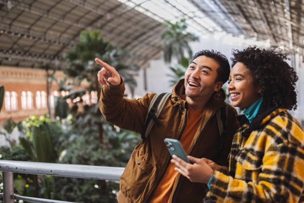 istock Smiling travelers exploring indoor botanical garden 2190246350