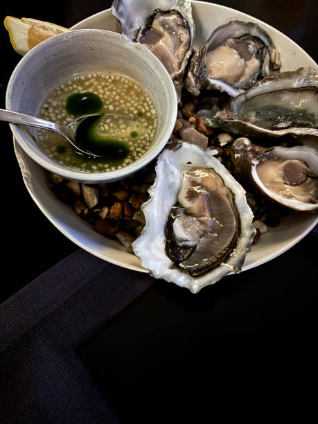 istock Fresh oysters with lemon and ice. Restaurant delicacy. oysters dish. Oyster dinner with champagne in restaurant, banner, menu, recipe place for text, top view, 2190246406